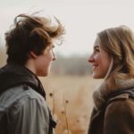 Young couple enjoying a moment outdoors with autumn backdrop.