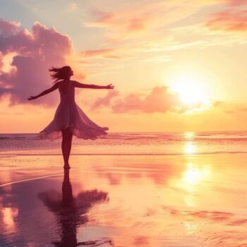 Woman dancing on the beach at sunset